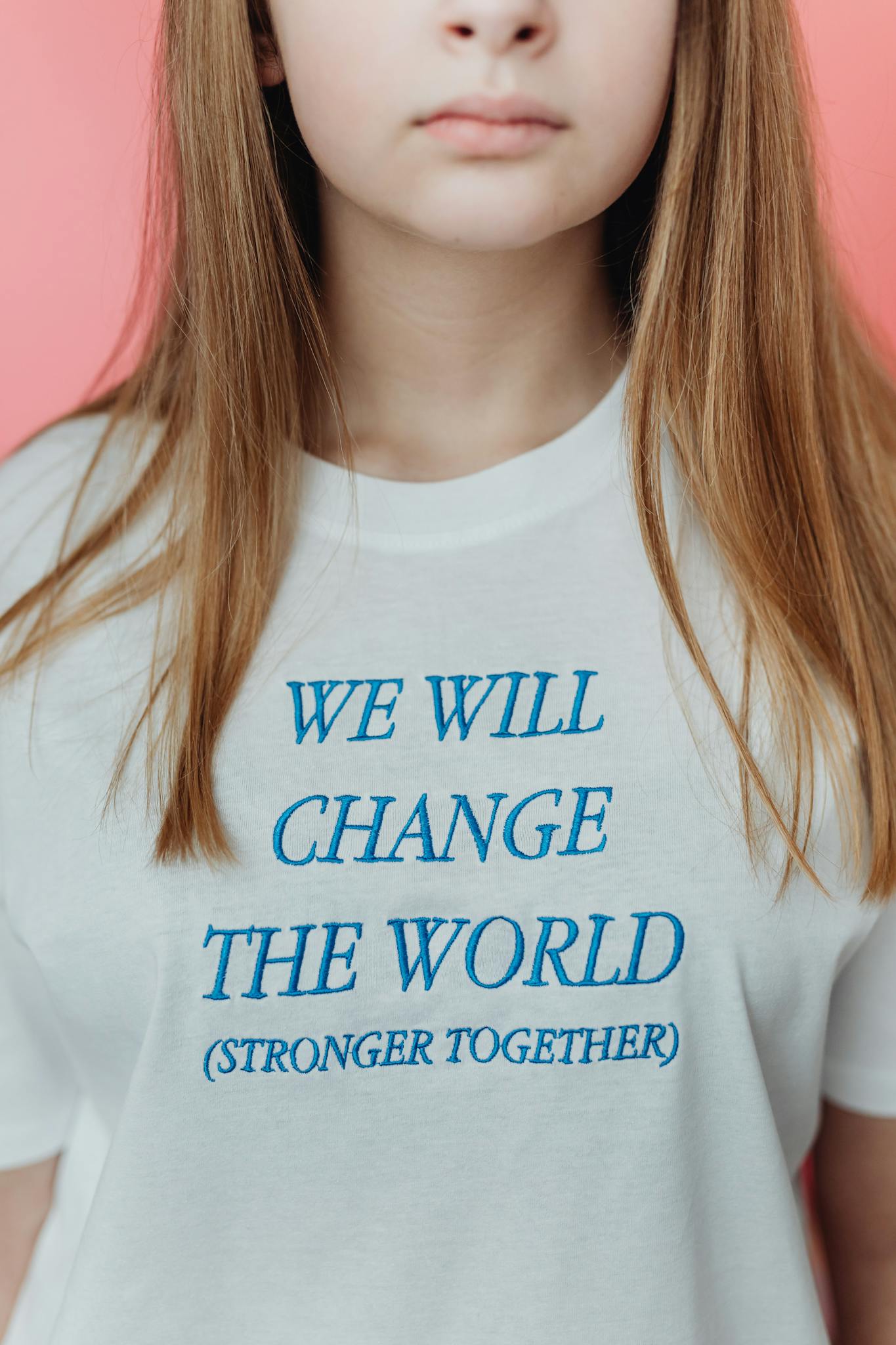 Close-up of a young woman wearing a white t-shirt with an empowering message.