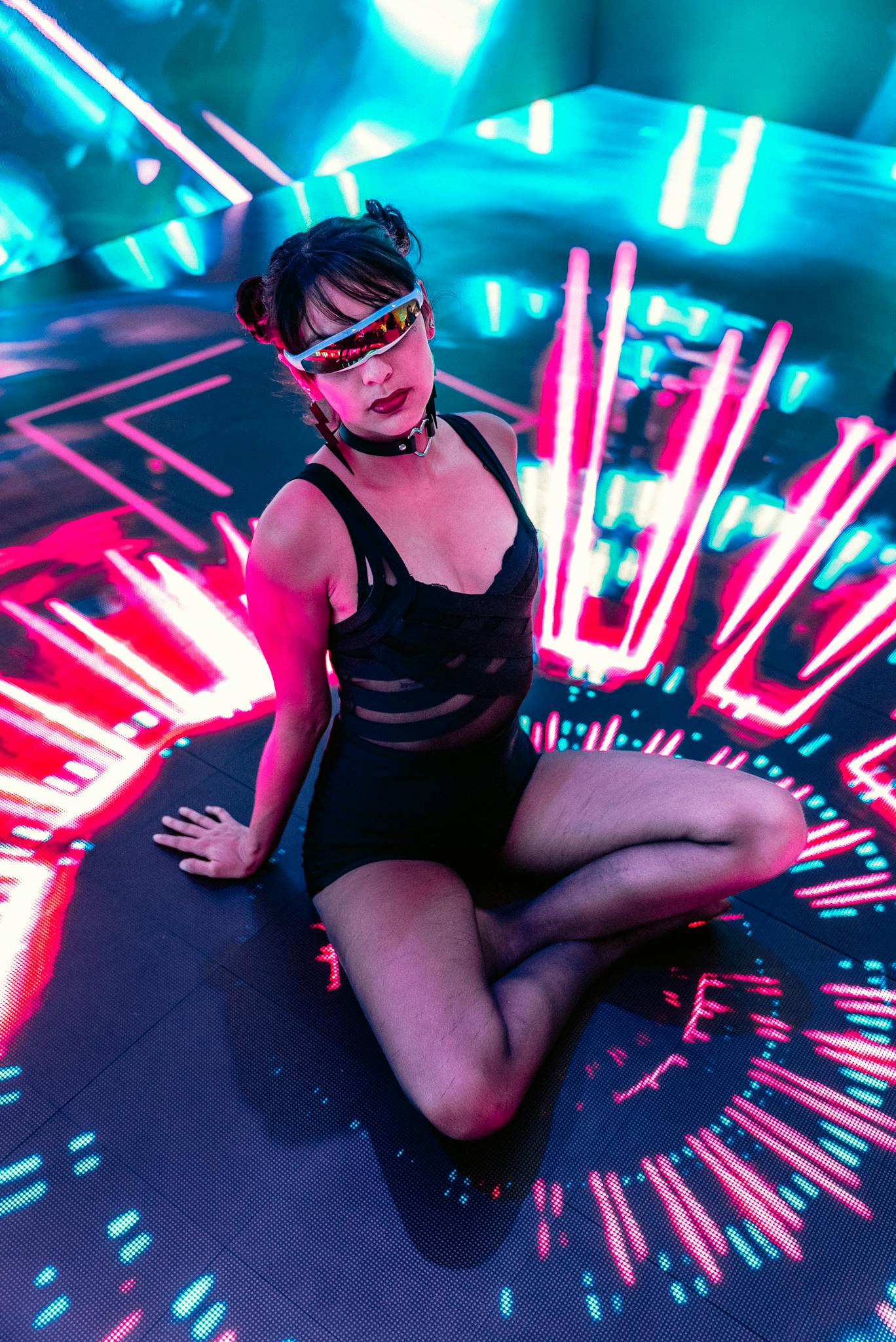 Energetic dancer in a neon-lit club with vibrant lights and futuristic vibes.